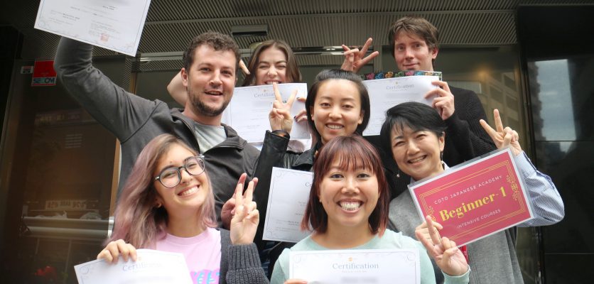 Group of students holding the certification for accomplishing Japanese lesson course