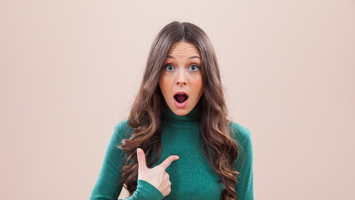 Woman pointing at herself