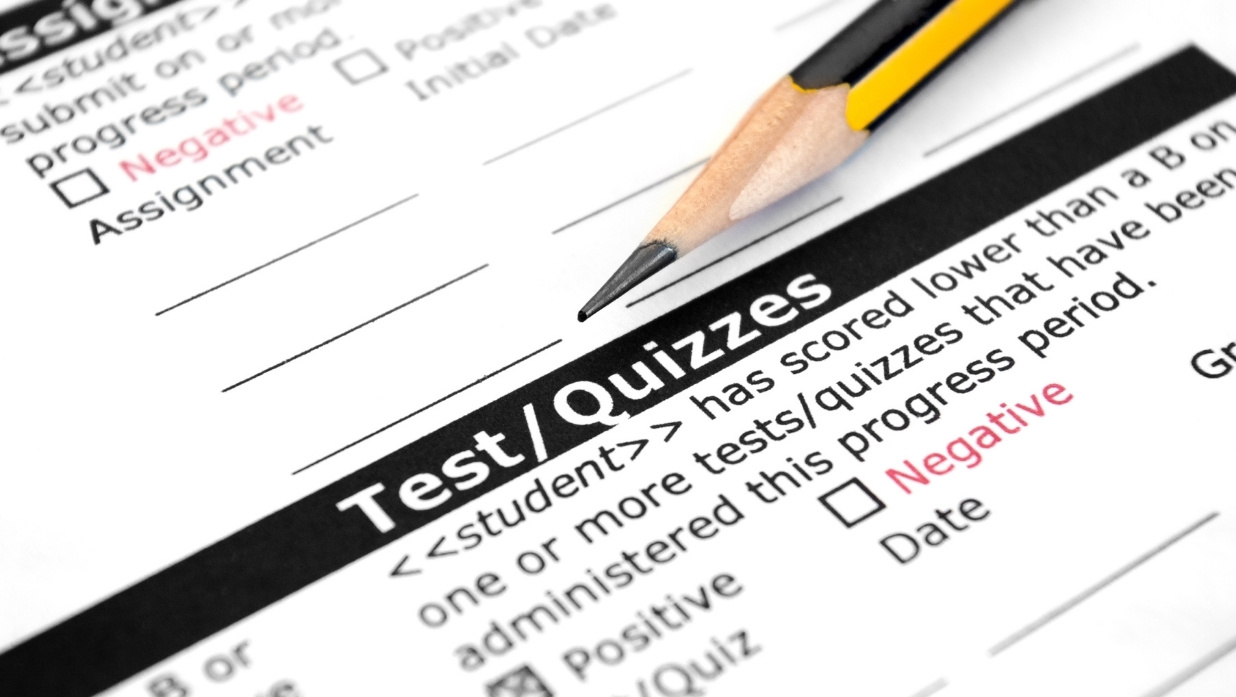 Pencil filling out a part of a paper test/quiz.