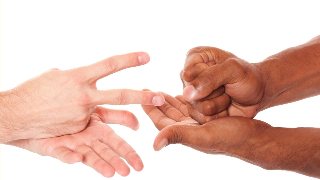 2 people playing rock paper scissors.