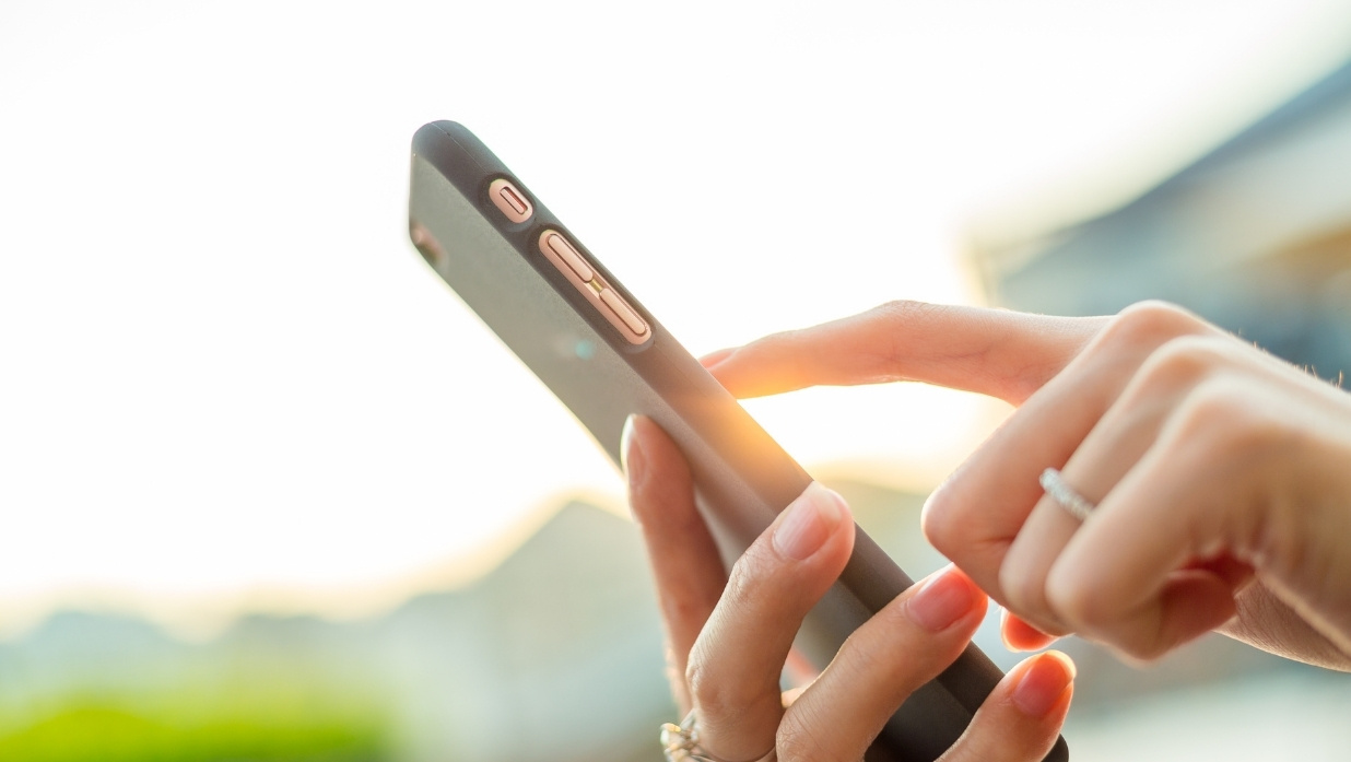 Woman using her cell phone outside