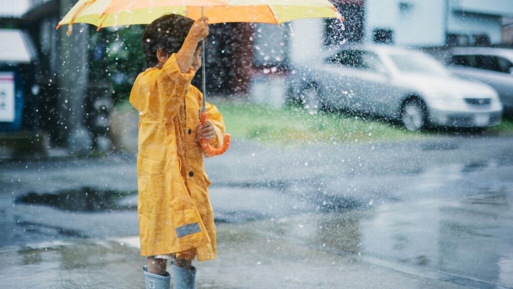 a child holding an umbrella for japanese rainy season