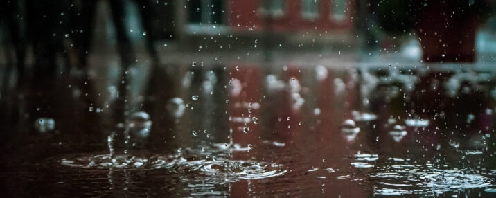 Rain hitting the pavement in a city
