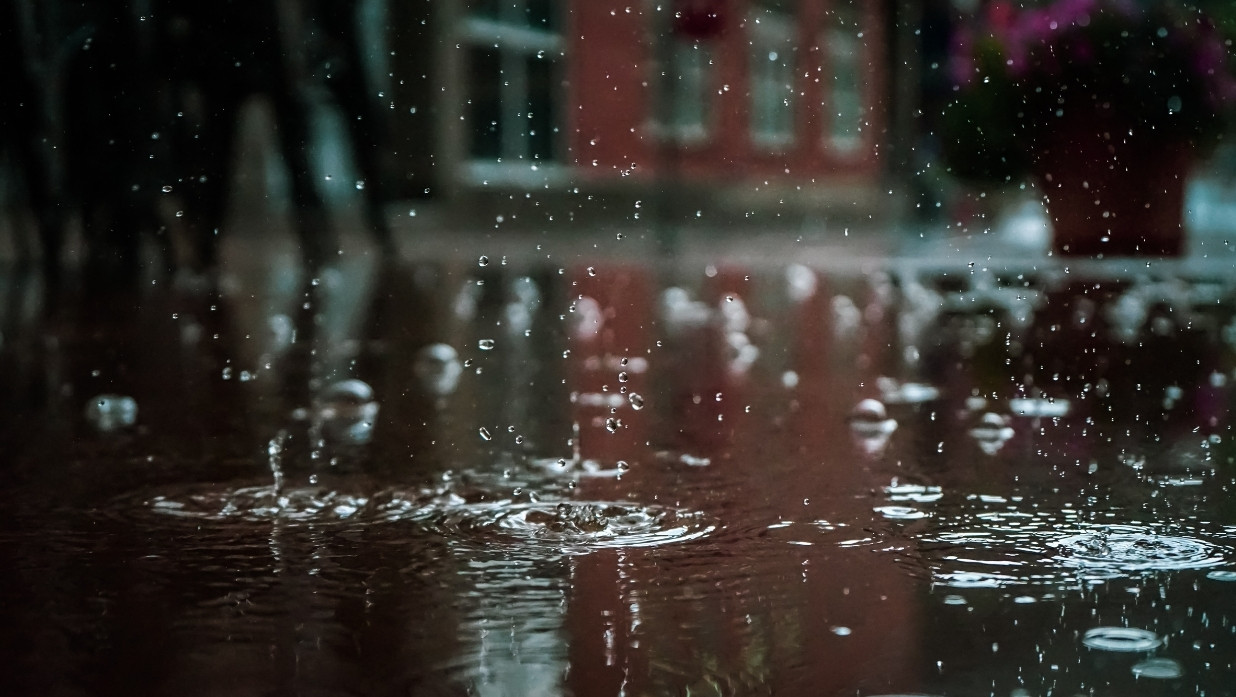 Rain hitting the pavement in a city
