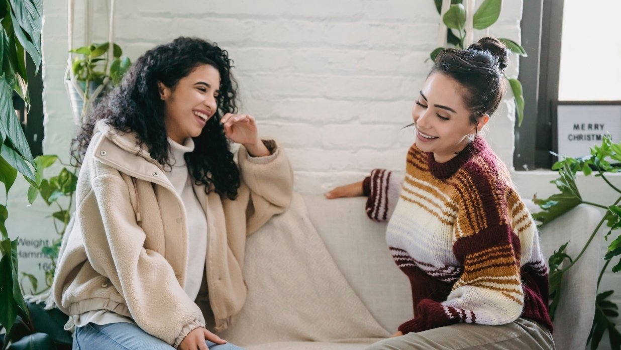 Picture of 2 friends talking to each other casually.