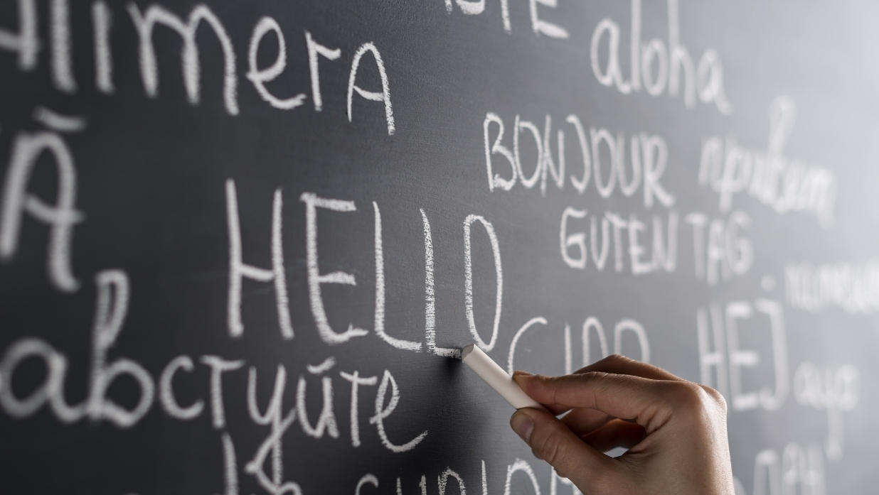 Languages saying hello on chalkboard.