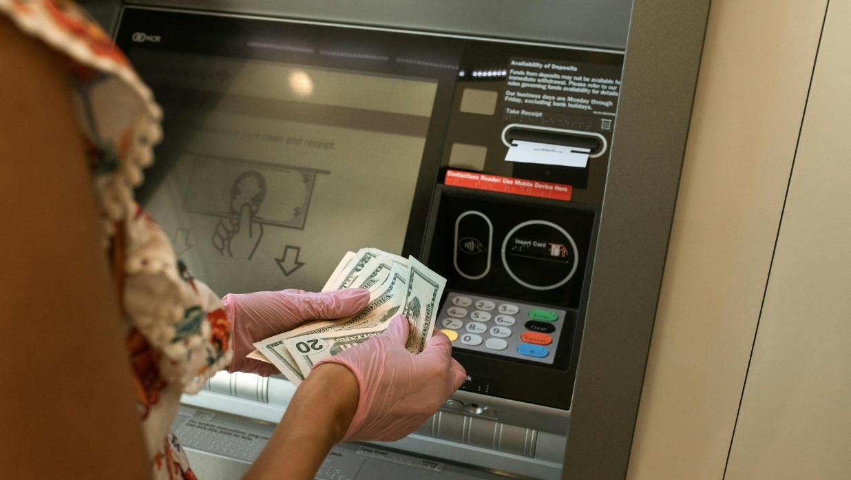 Woman withdrawing money from her bank account.
