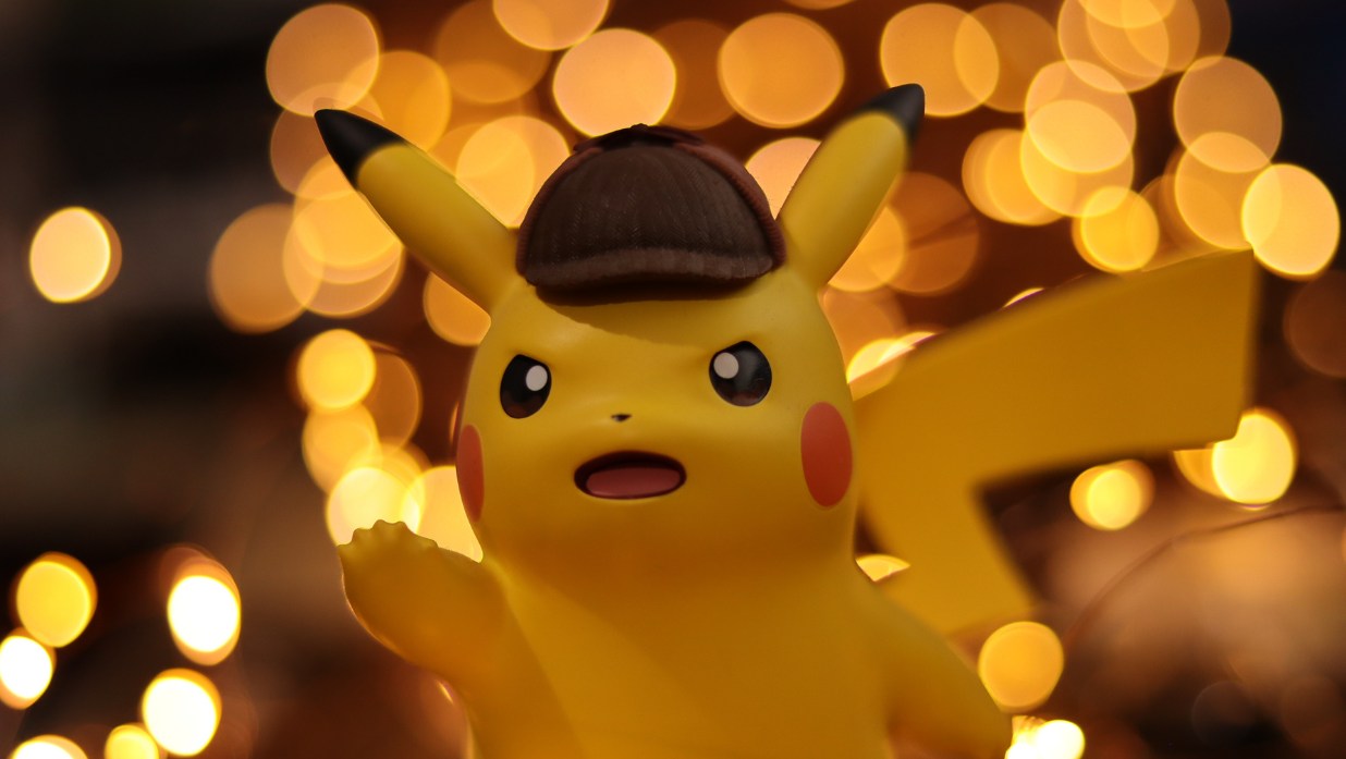 Feature image for the blog pokemon names in English vs Japanese showing a pikachu with sparks behind him