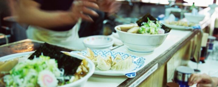 Restaurant with some orders of food, including 2 orders of ramen and some type of pork dumpling.