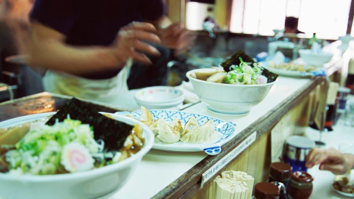 Restaurant with some orders of food, including 2 orders of ramen and some type of pork dumpling.