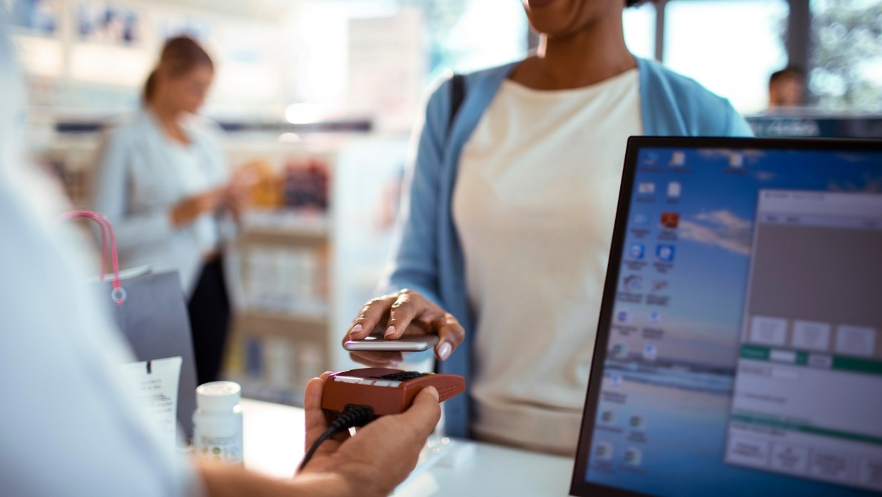 Person paying for a product using their phone.