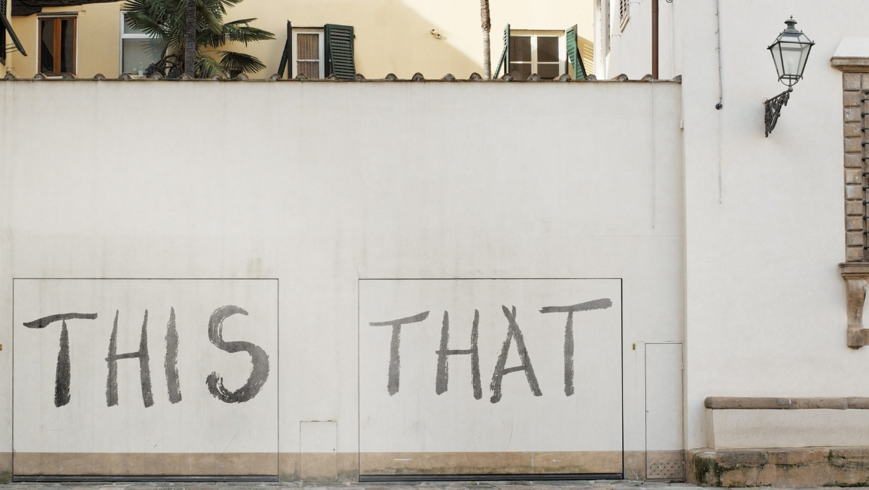 The words "this" and "that" written on a wall outside