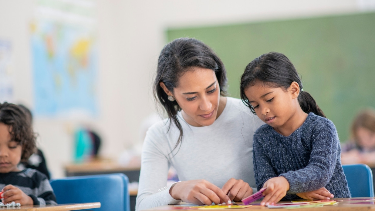 Teacher helping a student better understand a topic.