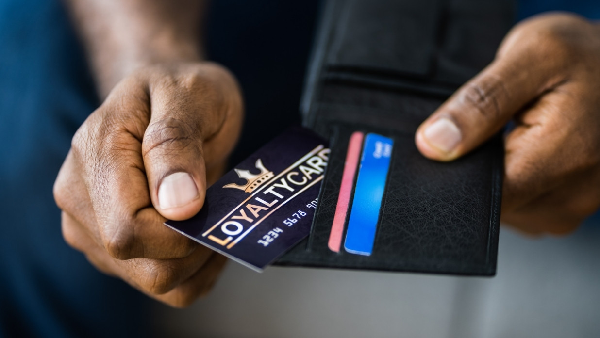 Someone getting a points card out of their wallet.