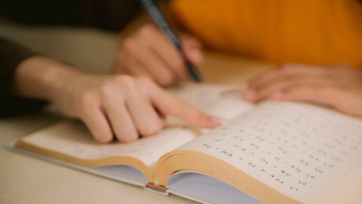 Someone helping a student with learning