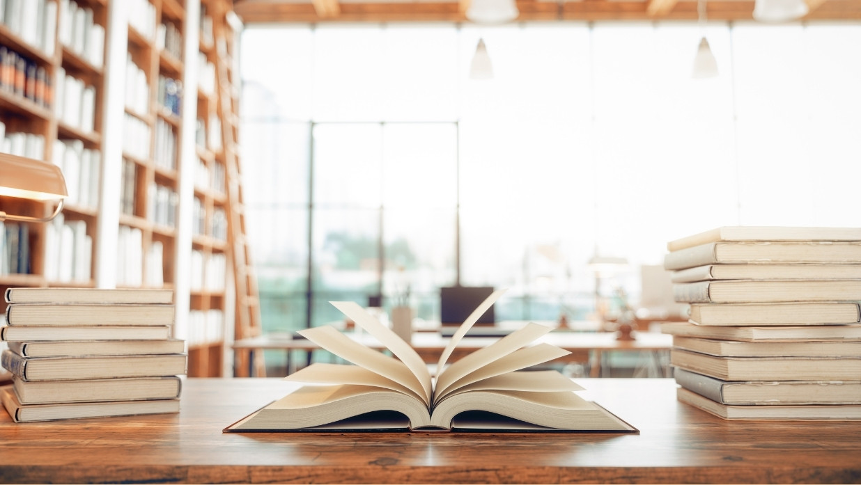 Many books out at a library to be studied.