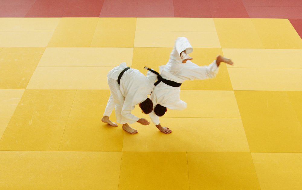 Judo Practitioners sparring with one executing a big throw