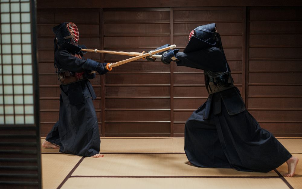 Practitioners practicing Kendo, weapon based combat sport in Japan while wearing the full armor.