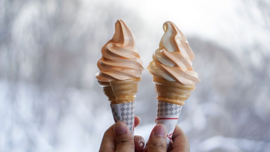 people holding 2 ice cream