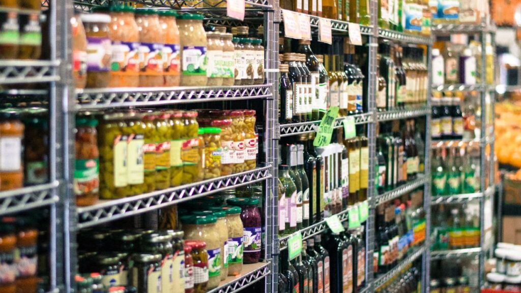 a rack full of pickles and spices in tokyo grocery stores