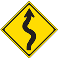 Japanese road sign indicating road will curve in different directions