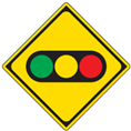 Japanese road sign showing a traffic light is ahead