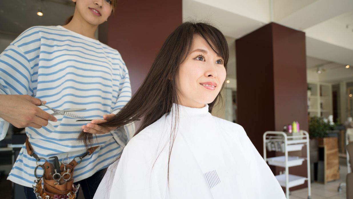 Woman getting a haircut in Japan