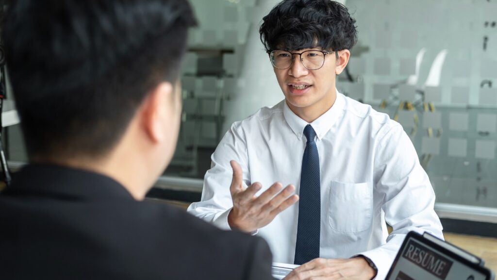 Feature image showing a man discussing his skills to interviewers