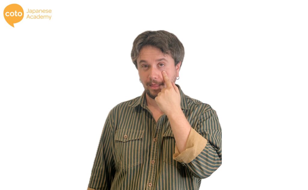 A childish Japanese hand gesture where you expose your lower eyelid to mock or tease someone.